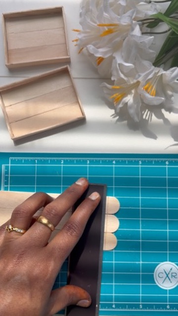 Measuring and marking wooden sticks on the cutting mat
