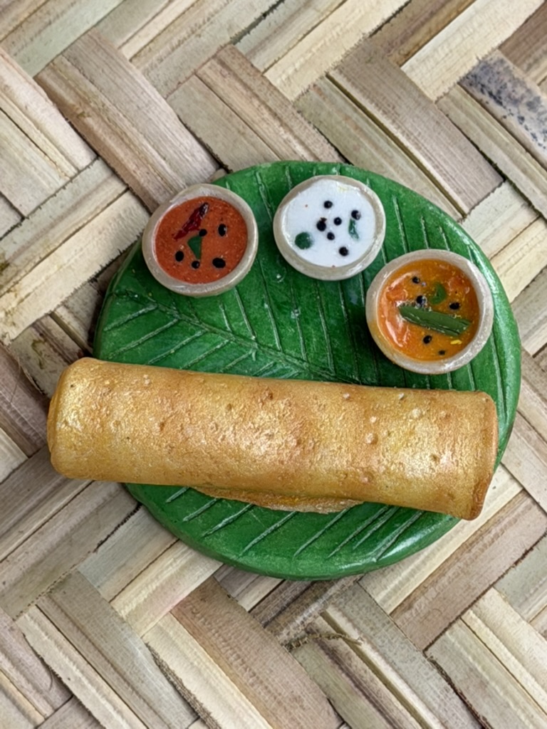 Miniature dosa on a banana leaf plate