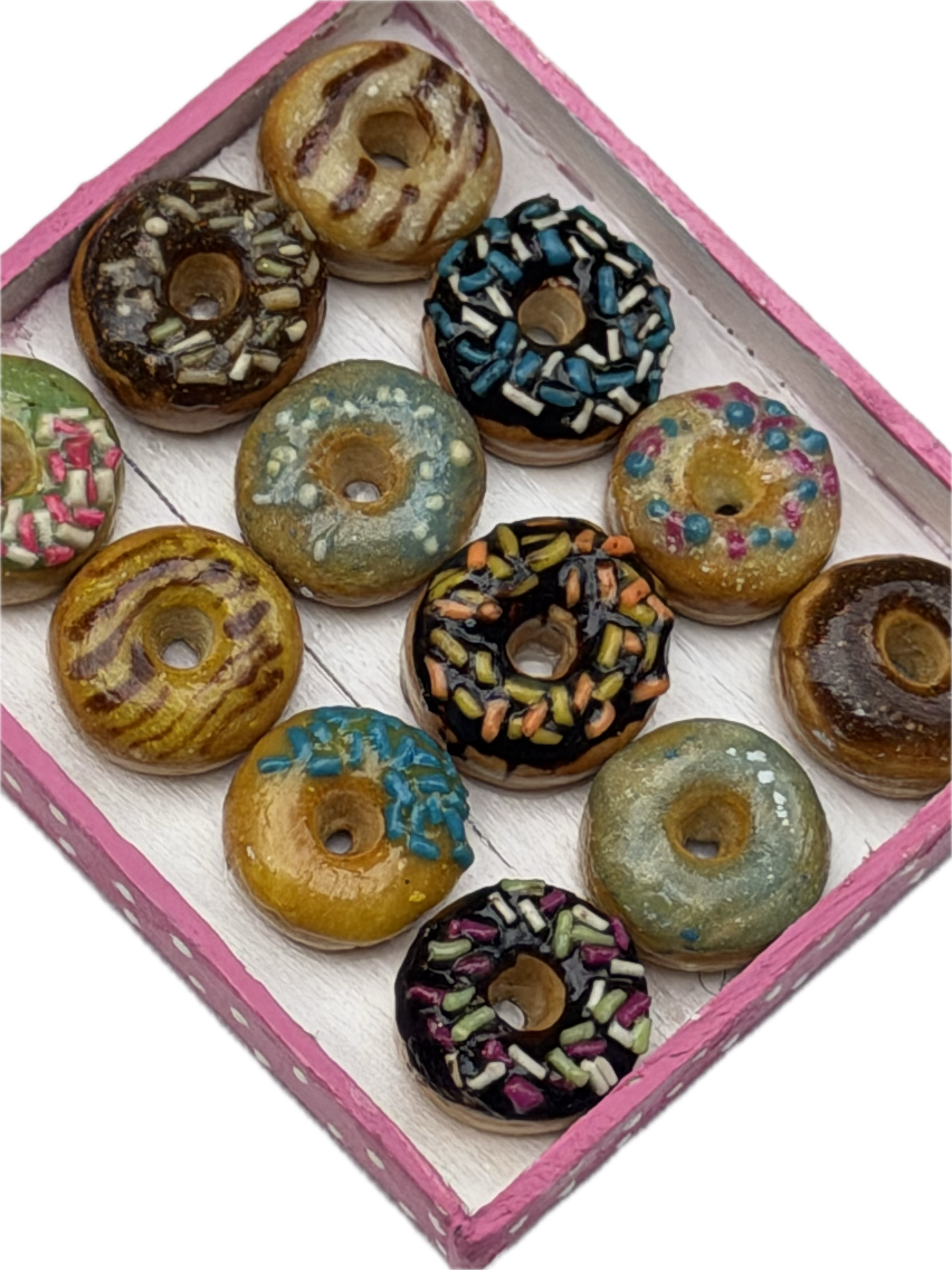 Miniature clay donuts in a painted pink box