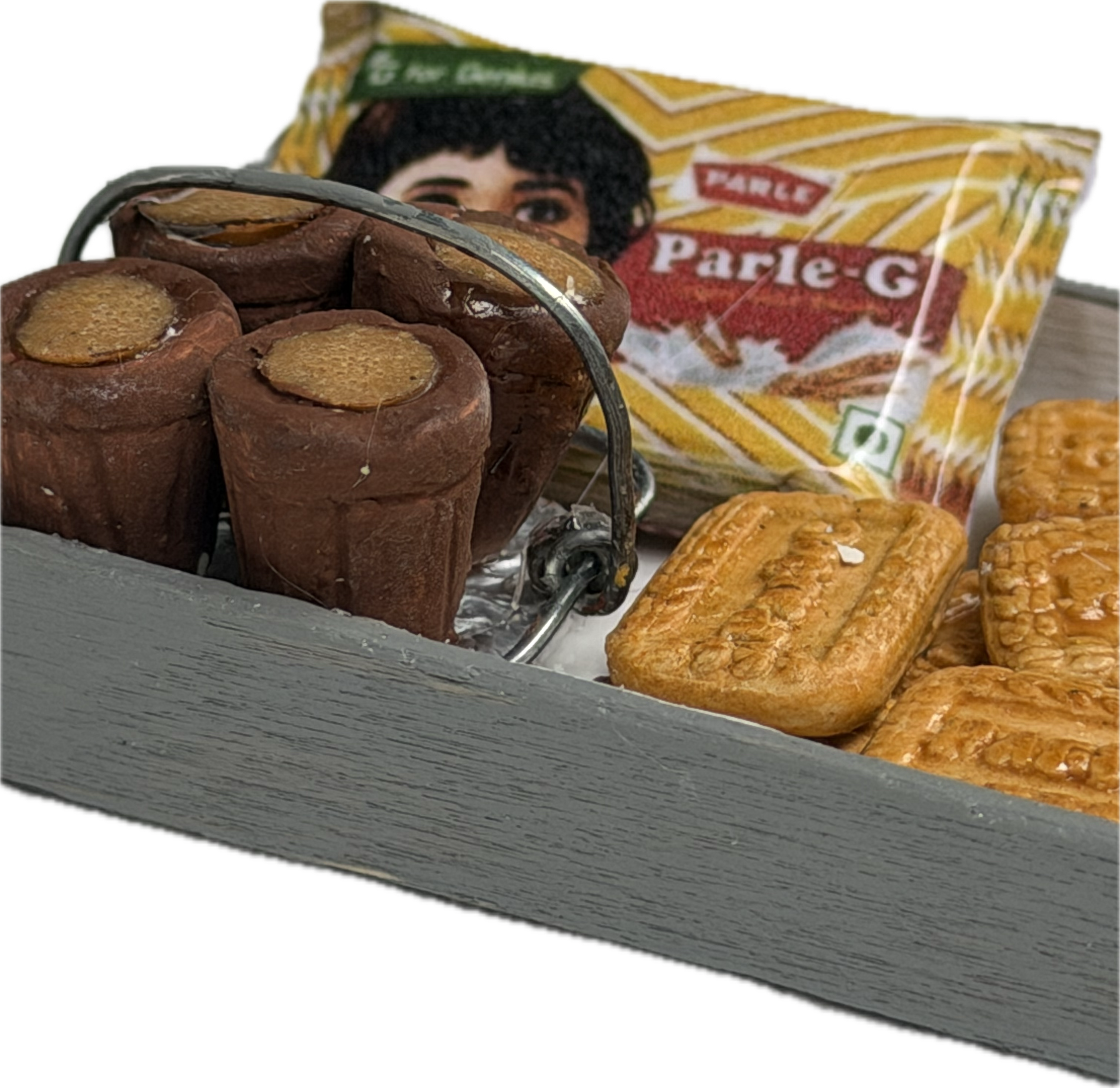 Miniature tea glasses and biscuits on a grey tray